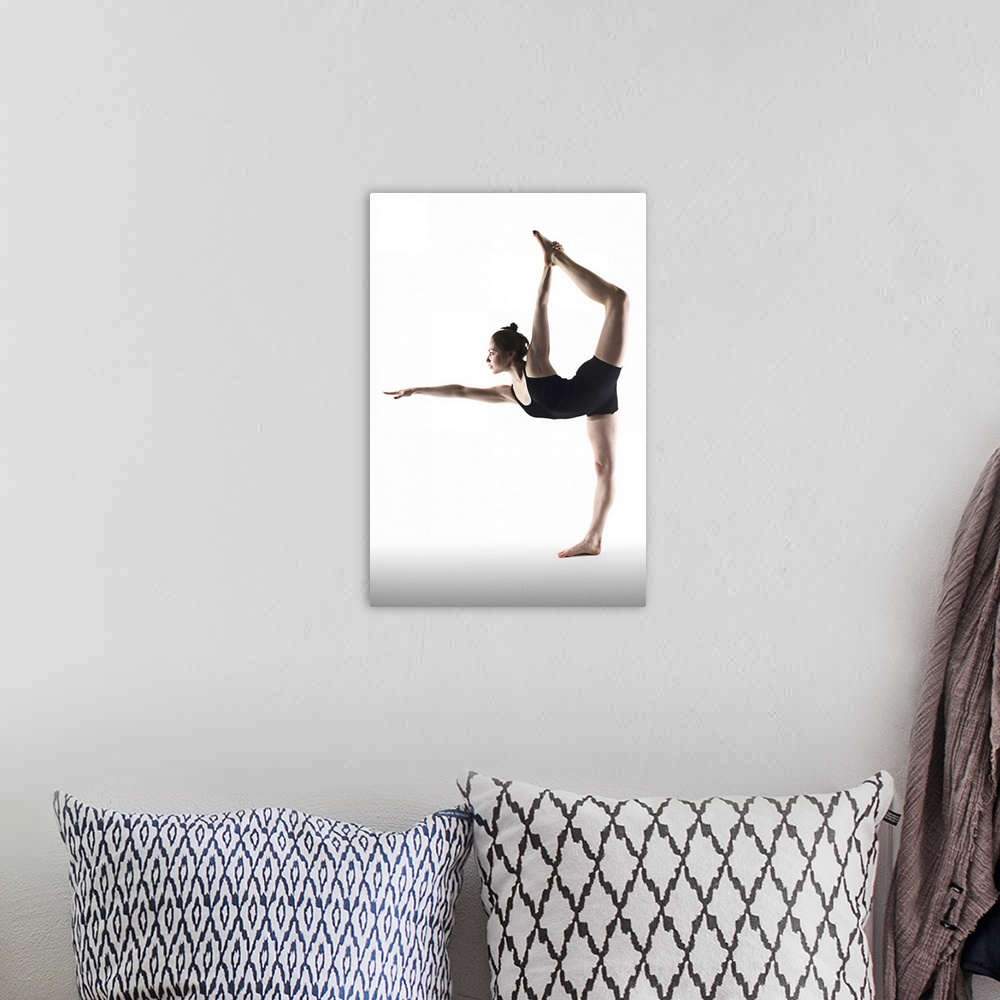 A bohemian room featuring Young woman standing yoga pose on white background.
