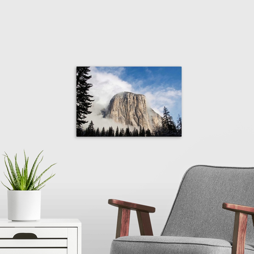 A modern room featuring Yosemite in November El Capitan coming out of fog.