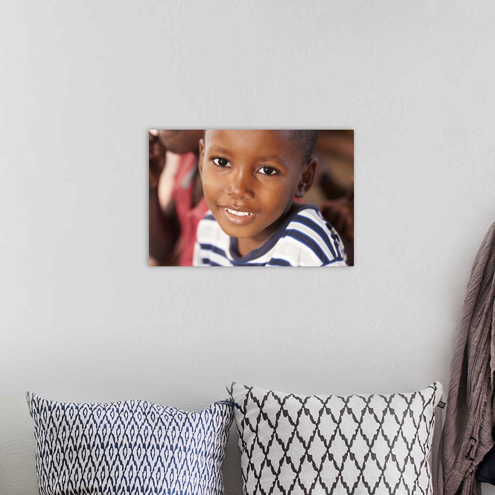 A bohemian room featuring Portrait of a young 5-7 male in Haiti smiling
