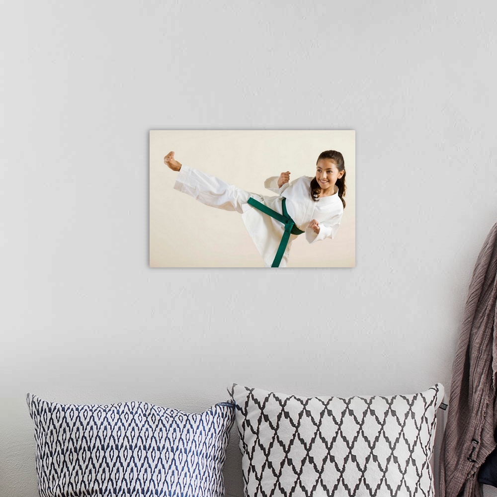 A bohemian room featuring Young girl doing karate kick