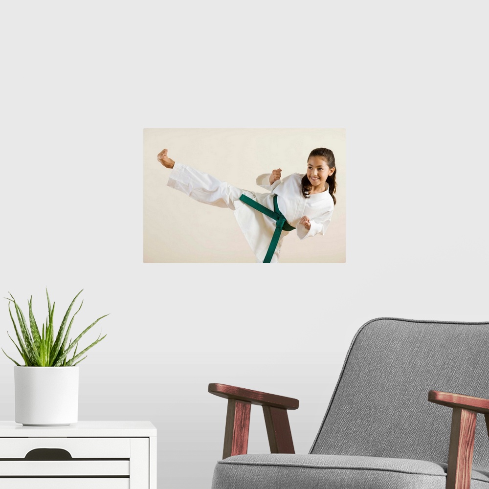 A modern room featuring Young girl doing karate kick