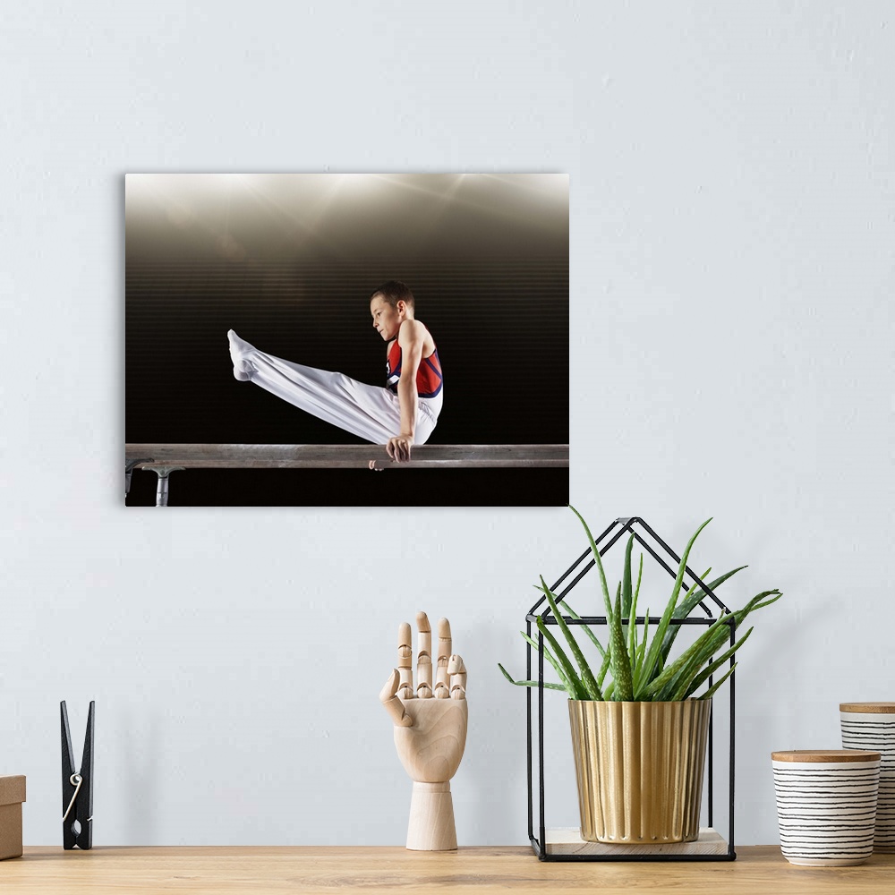 A bohemian room featuring Young male gymnast performing on parallel bars