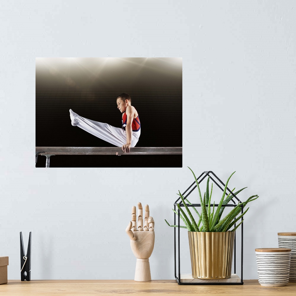A bohemian room featuring Young male gymnast performing on parallel bars