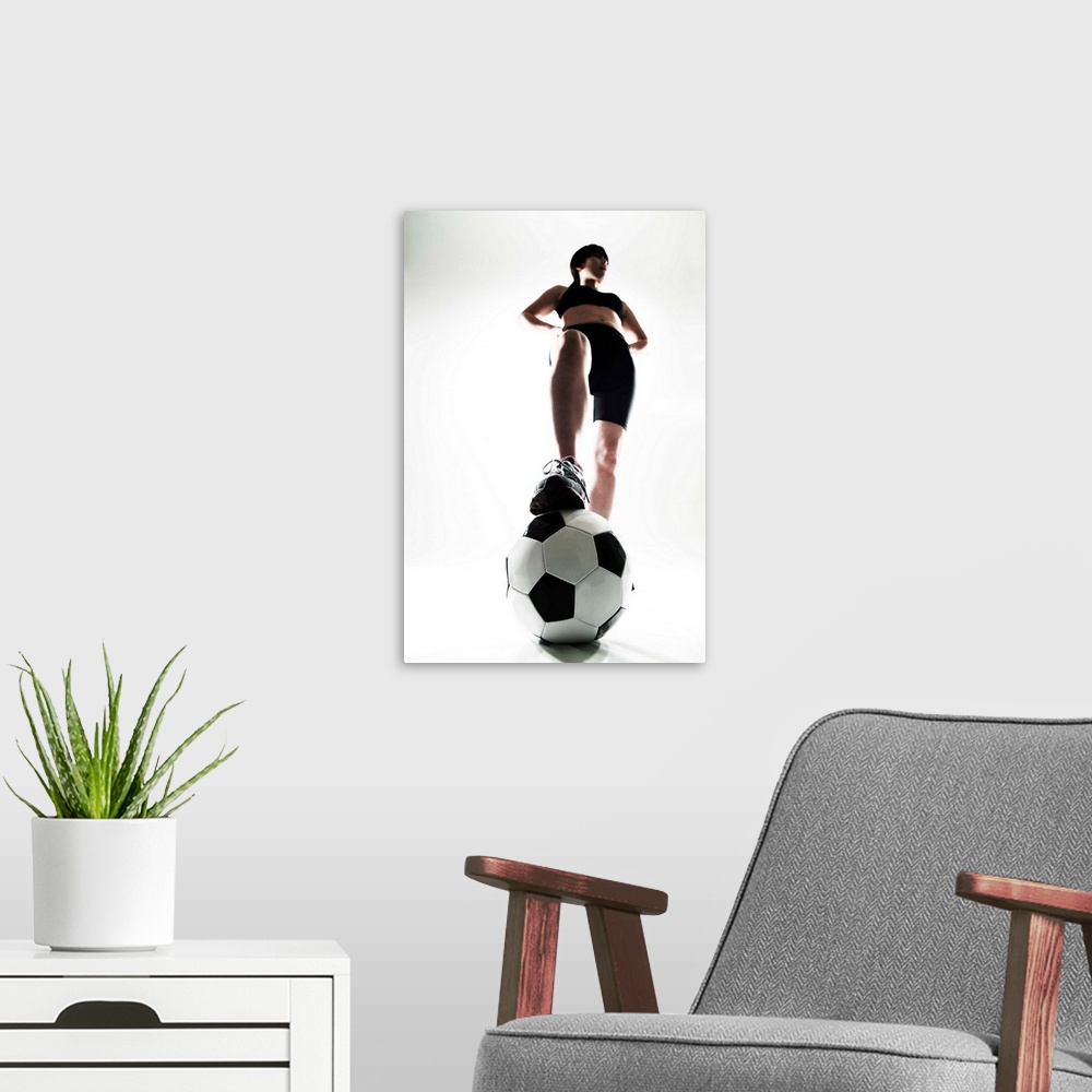 A modern room featuring Young woman training, soccer