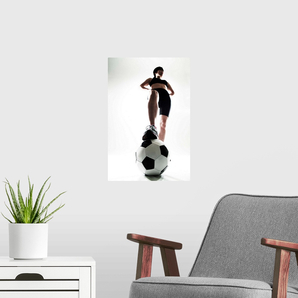 A modern room featuring Young woman training, soccer