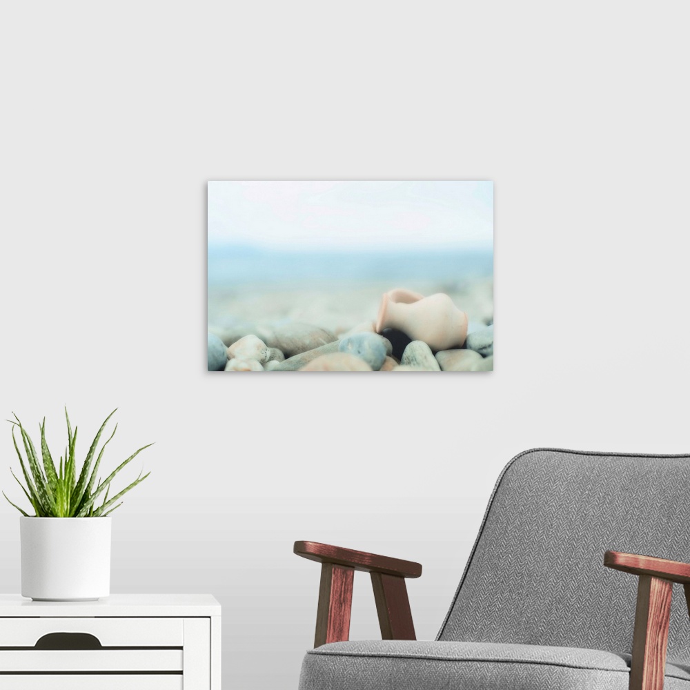 A modern room featuring Zen composition on pebble beach, small amphora on  lies pebbles.