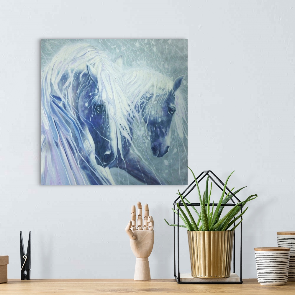 A bohemian room featuring Watercolor painting of a dream-like scene of two horses in shades of blue.