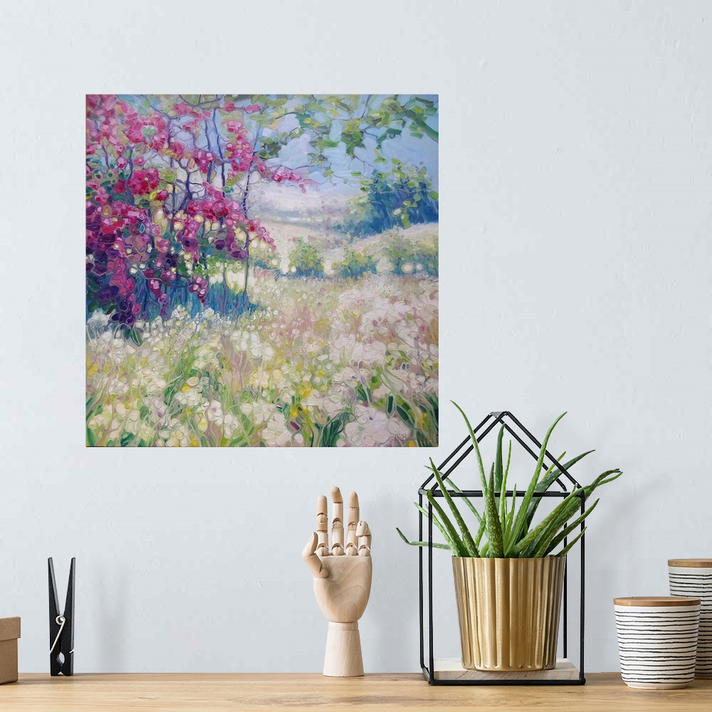 A bohemian room featuring A square painting of a spring time scene in a meadow with blooming flowers of pink and white.