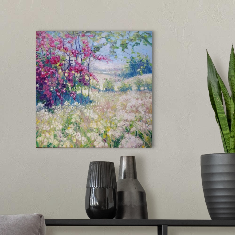 A modern room featuring A square painting of a spring time scene in a meadow with blooming flowers of pink and white.