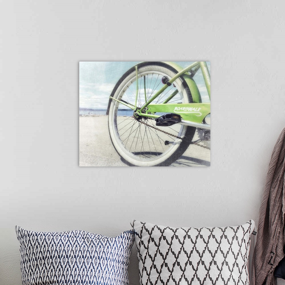 A bohemian room featuring Aged photograph of the rear of a green bicycle with a slightly blown out beach scene in the backg...