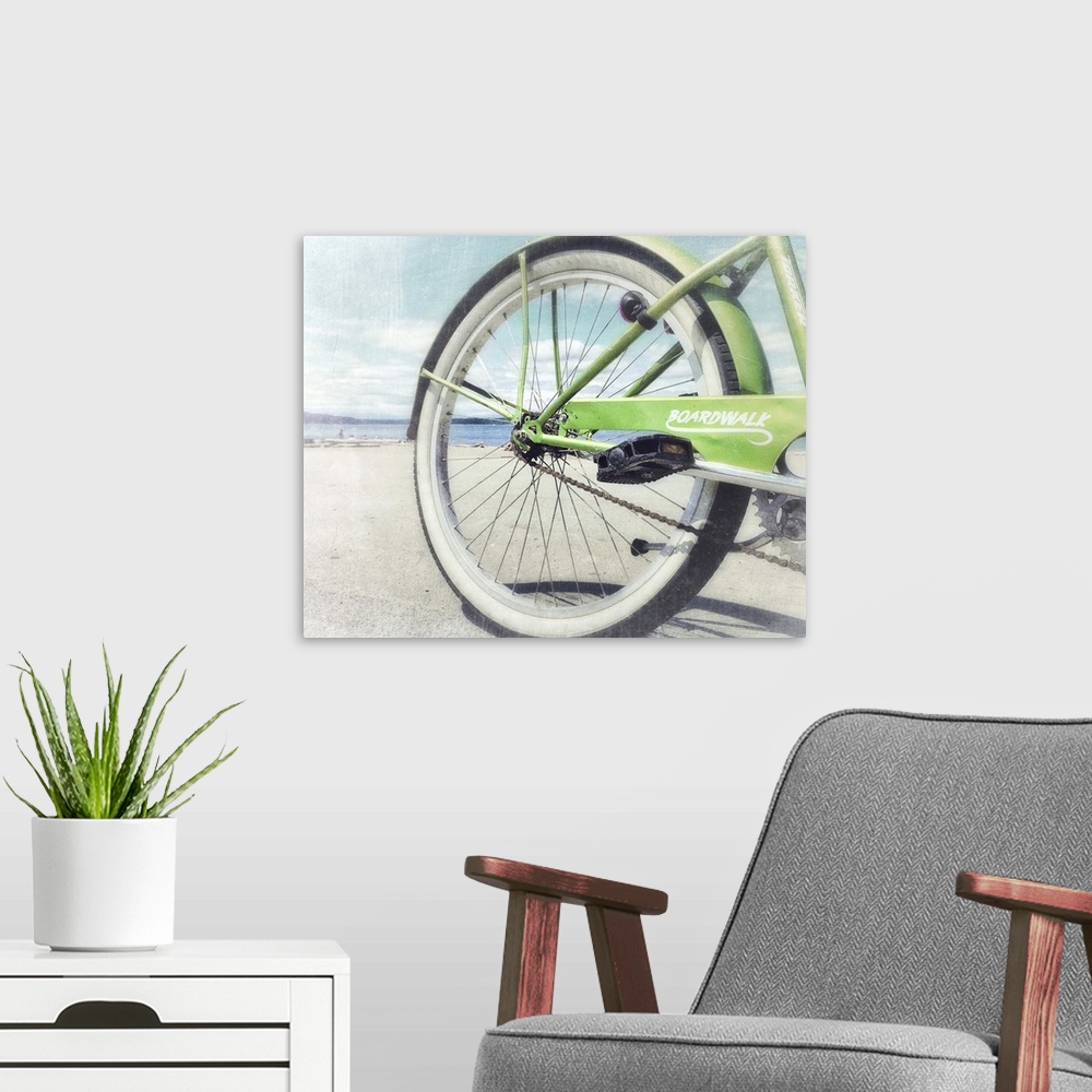 A modern room featuring Aged photograph of the rear of a green bicycle with a slightly blown out beach scene in the backg...