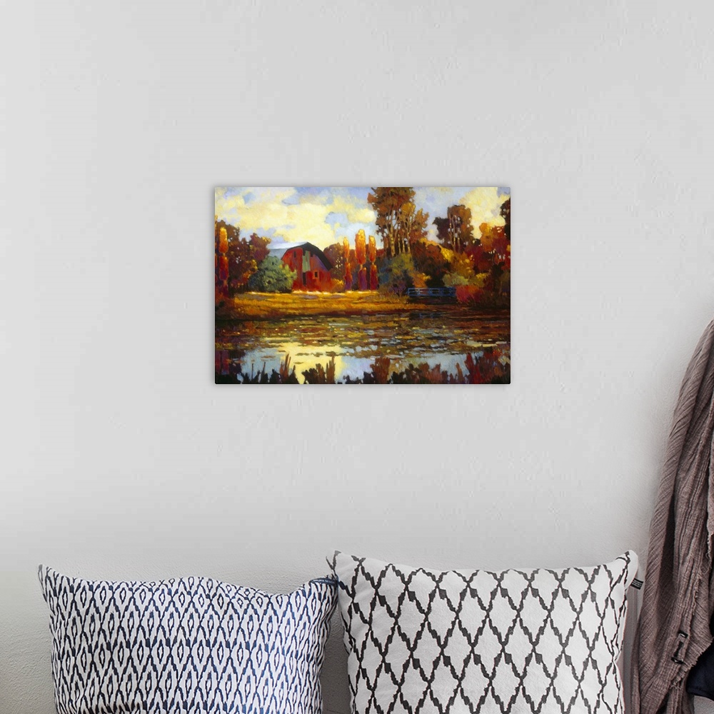 A bohemian room featuring Painting on canvas of an old barn with fall foliage around it by a lake.