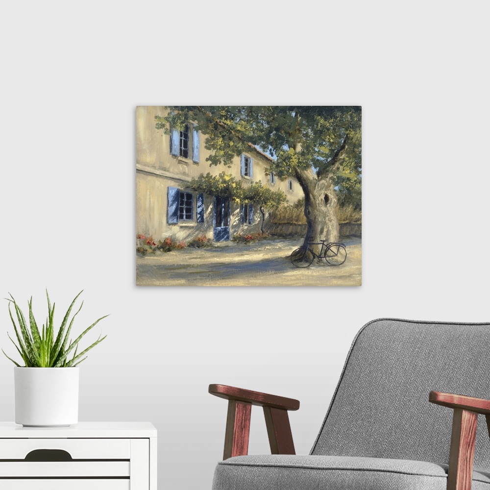 A modern room featuring A European country home with a large tree in the front yard with a bicycle.