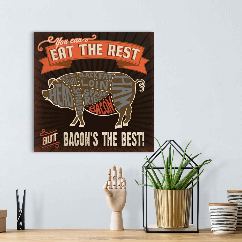 A bohemian room featuring Contemporary food themed artwork of a butcher diagram of a pig and the different cuts of meat.