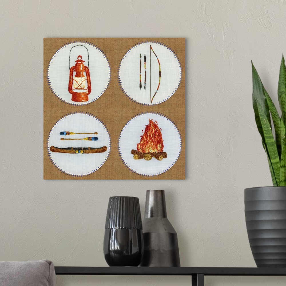A modern room featuring Square embroidered cabin art art of a lantern, canoe, bow and arrow, and fire pit.