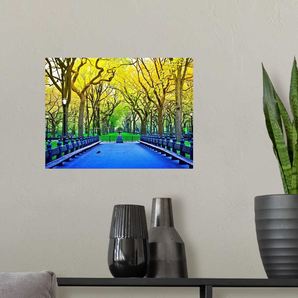 A modern room featuring Vividly colored photograph of a bridge surrounded by trees in Central Park.