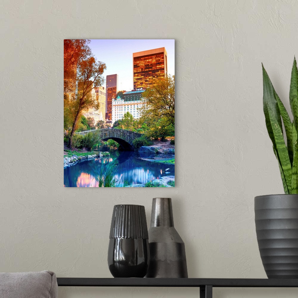 A modern room featuring Vividly colored photograph of a bridge over a stream in Central Park, with skyscrapers in the dis...