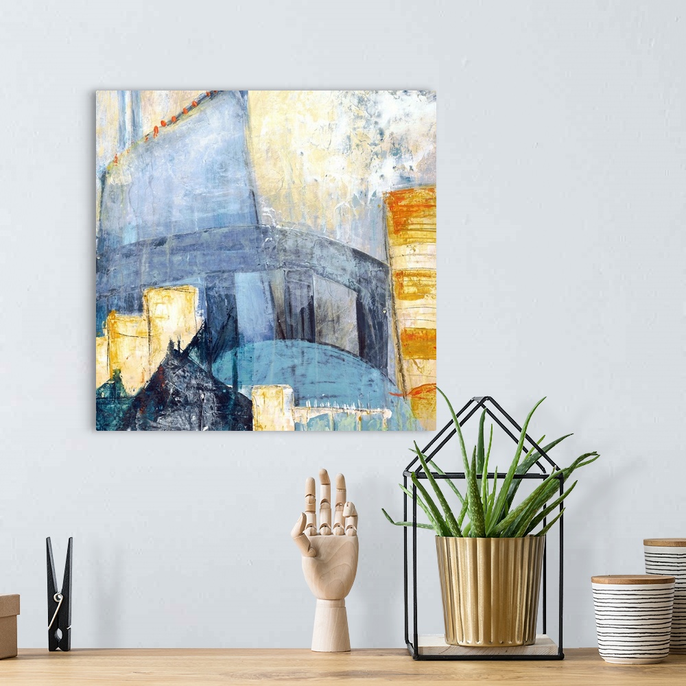 A bohemian room featuring Square abstract painting of a cityscape using shades of blue, yellow, orange, and grey.