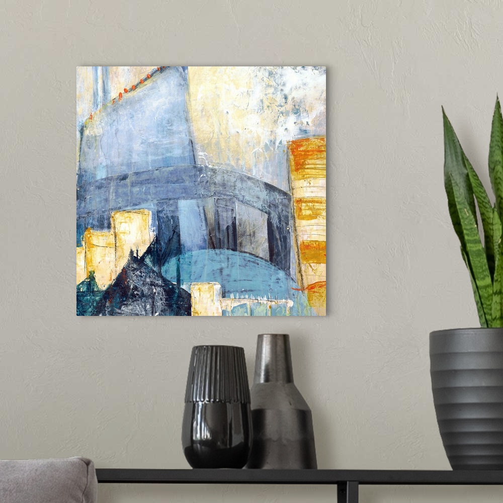 A modern room featuring Square abstract painting of a cityscape using shades of blue, yellow, orange, and grey.