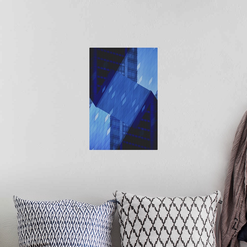 A bohemian room featuring Blue abstract art of a building folded into different angles and placed all together as one.