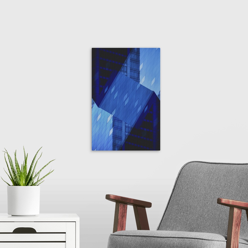 A modern room featuring Blue abstract art of a building folded into different angles and placed all together as one.