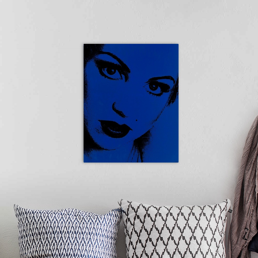 A bohemian room featuring Blue and black pointillism illustration of a close up woman's face.
