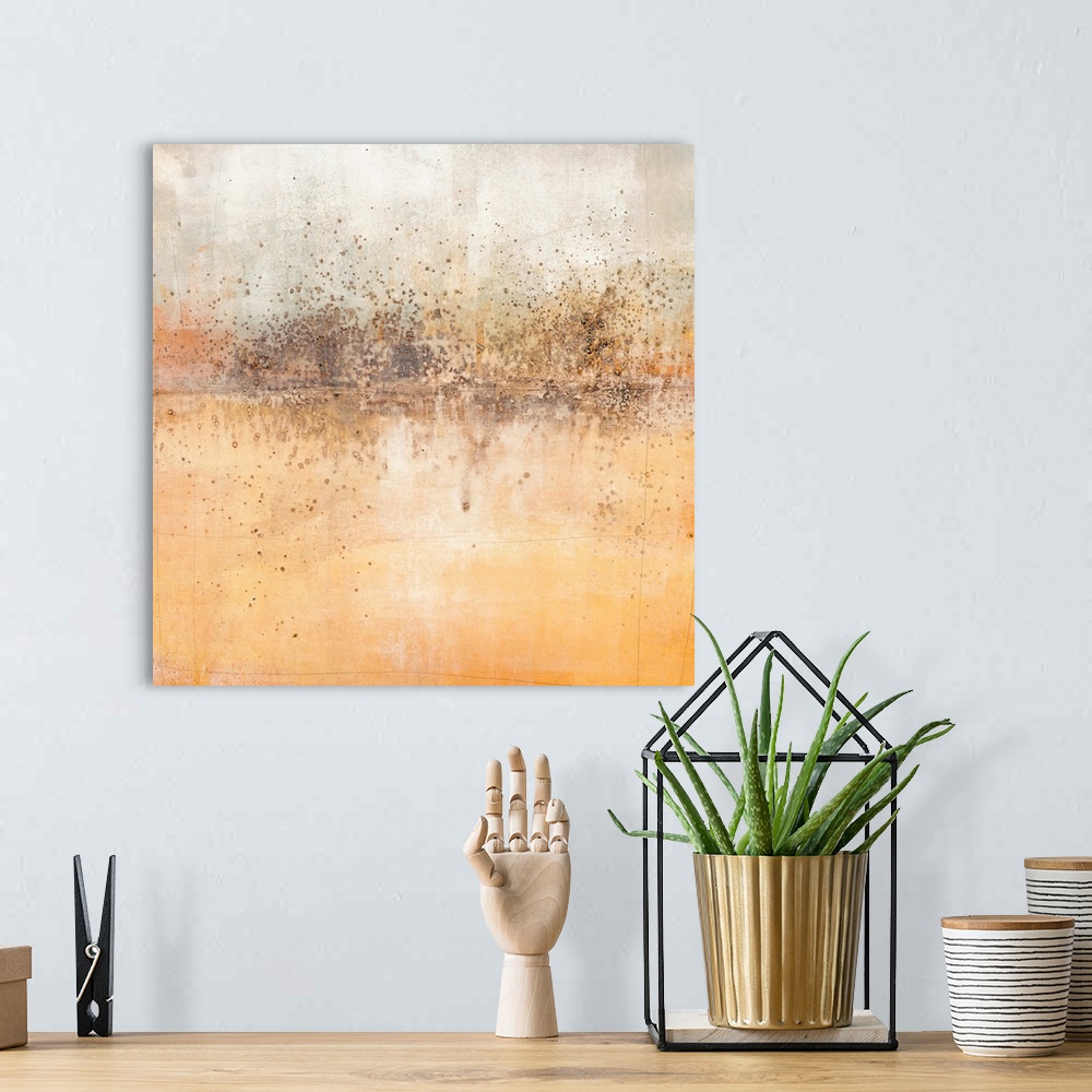 A bohemian room featuring Square abstract painting with a brown paint splattered horizon line and shades of orange, grey, a...