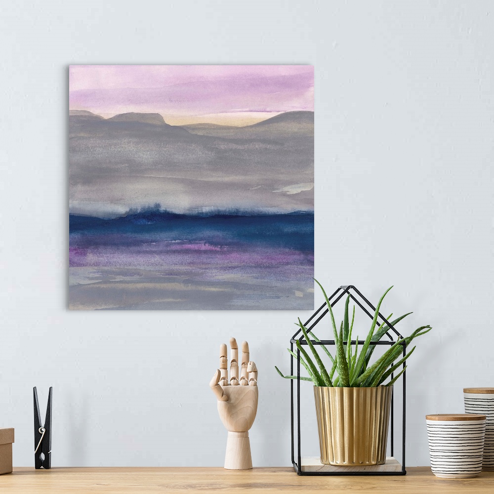 A bohemian room featuring Watercolor landscape painting with grey hills and a lavender sky.