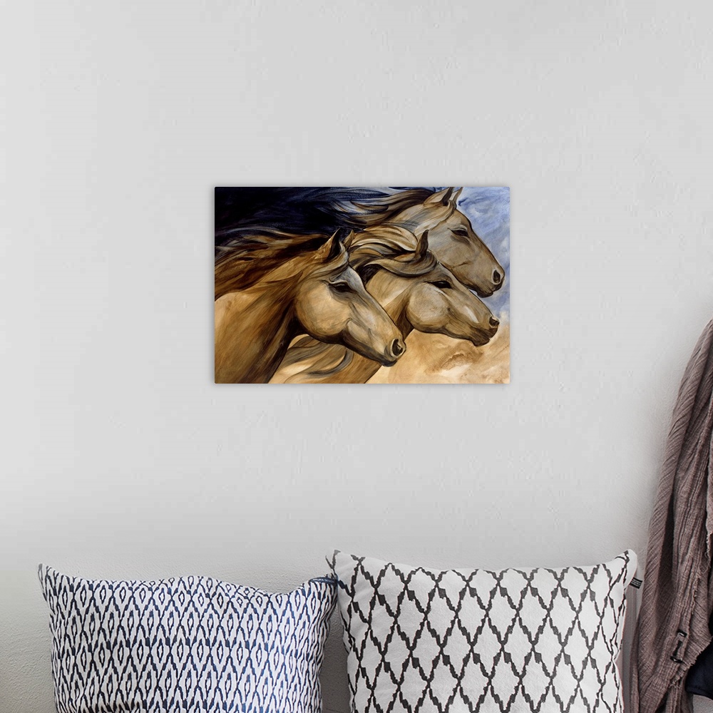 A bohemian room featuring Artwork of three horse heads in neutral tones.