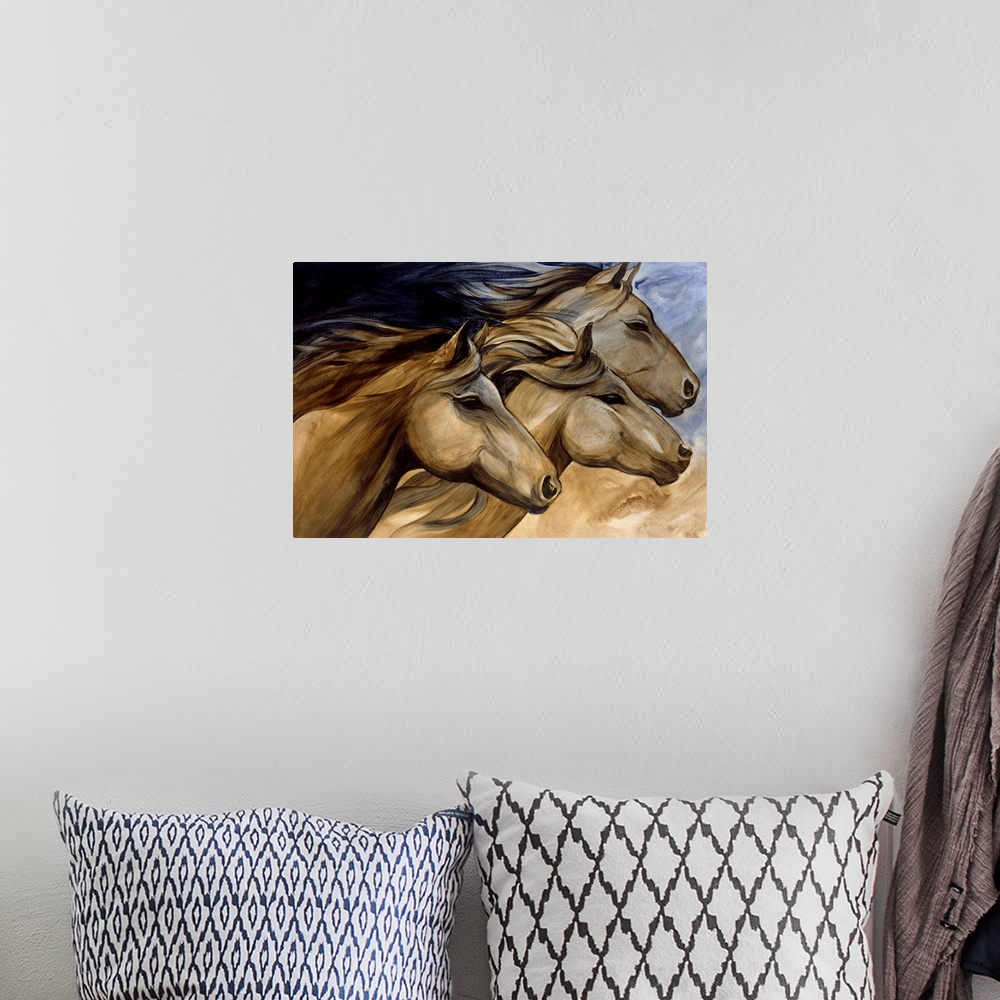 A bohemian room featuring Artwork of three horse heads in neutral tones.