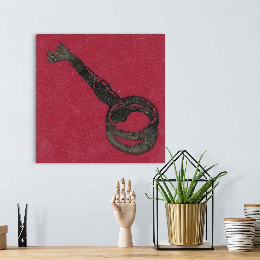 A bohemian room featuring Square art of an antique key on a red background.