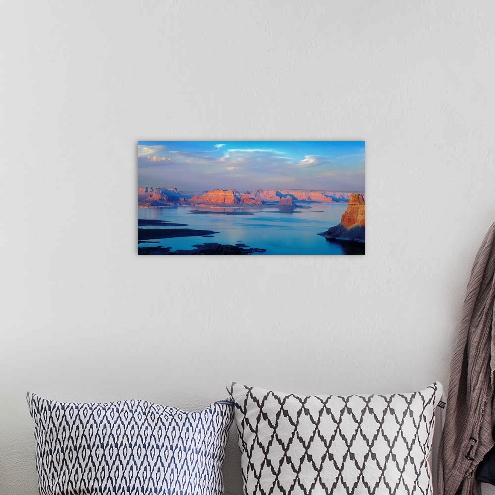 A bohemian room featuring A photograph of lake powell under sky with approaching clouds.