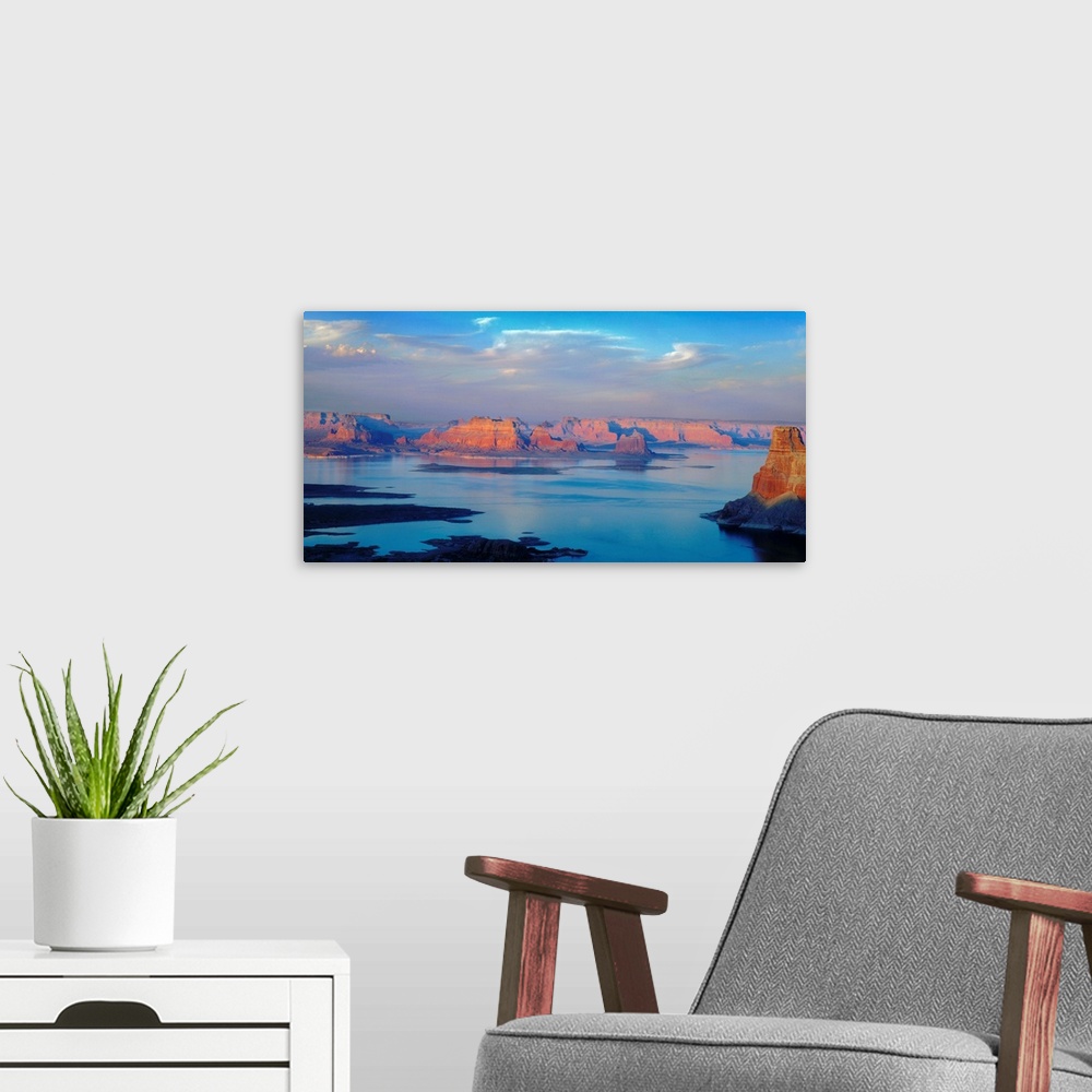 A modern room featuring A photograph of lake powell under sky with approaching clouds.