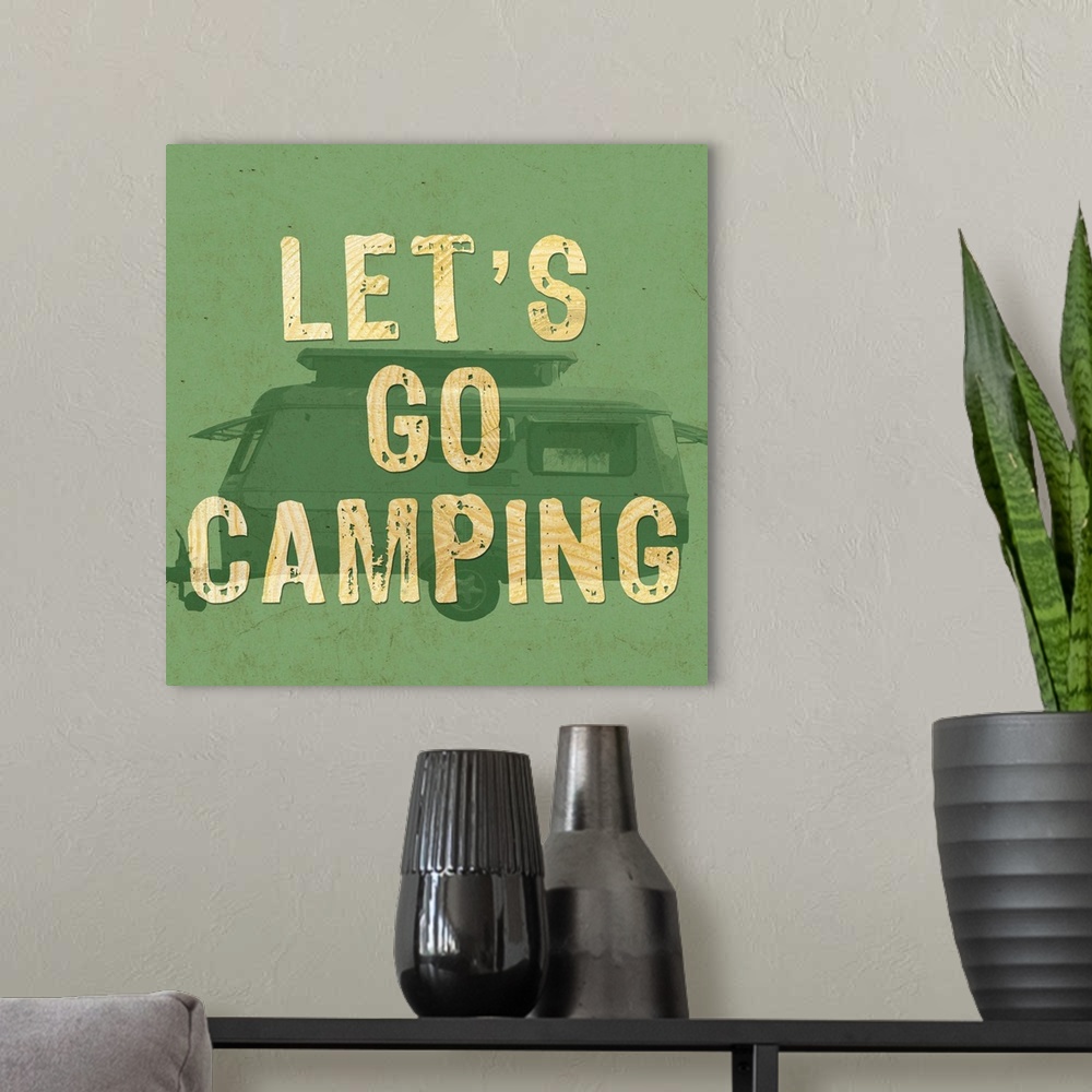 A modern room featuring A green-toned image of a recreational trailer with the words "Let's go camping."