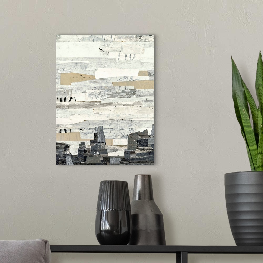 A modern room featuring Abstract art with strips of neutral colors pasted together to create a rocky landscape.