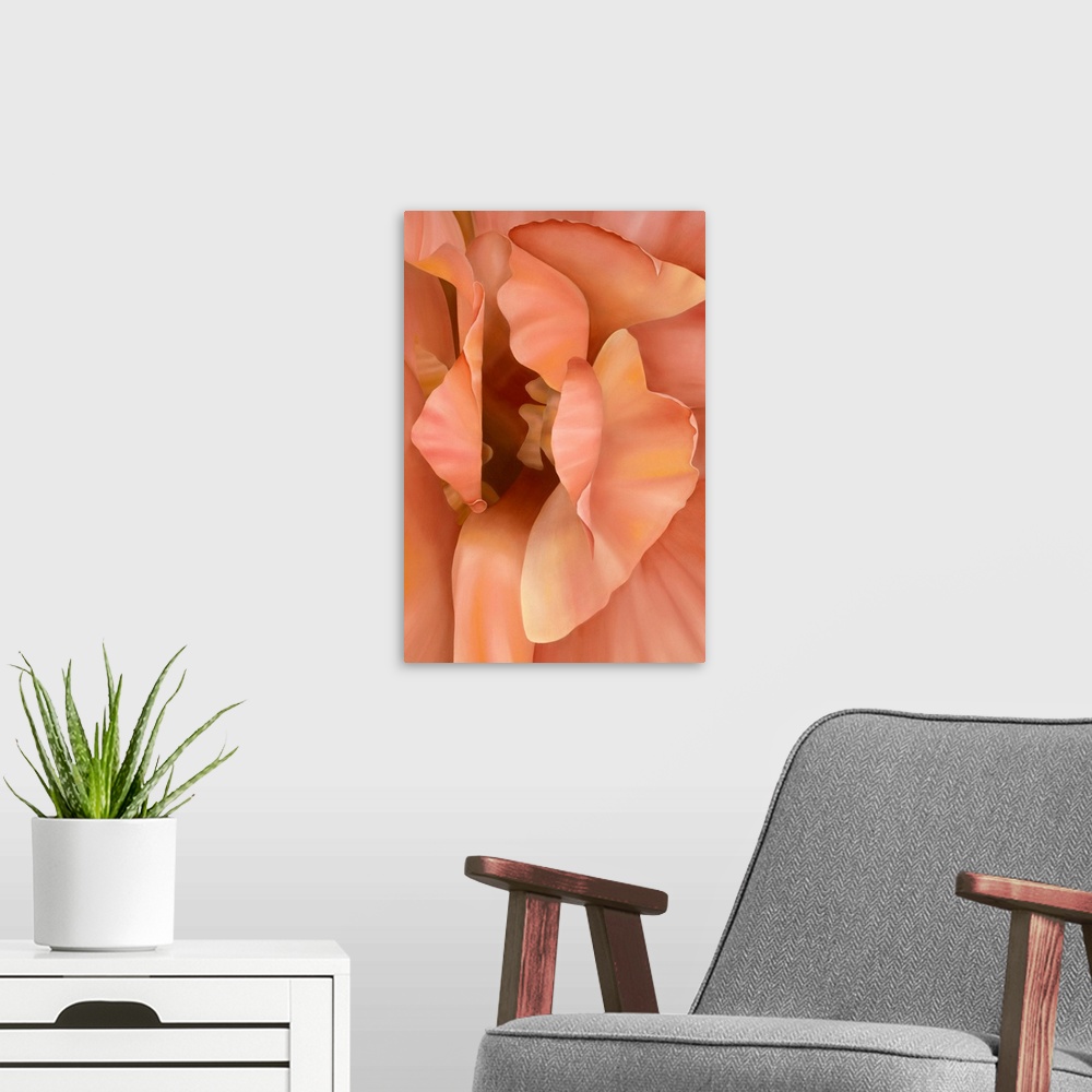 A modern room featuring Vertical close up floral painting of layers of petals in a light yellow and orange.