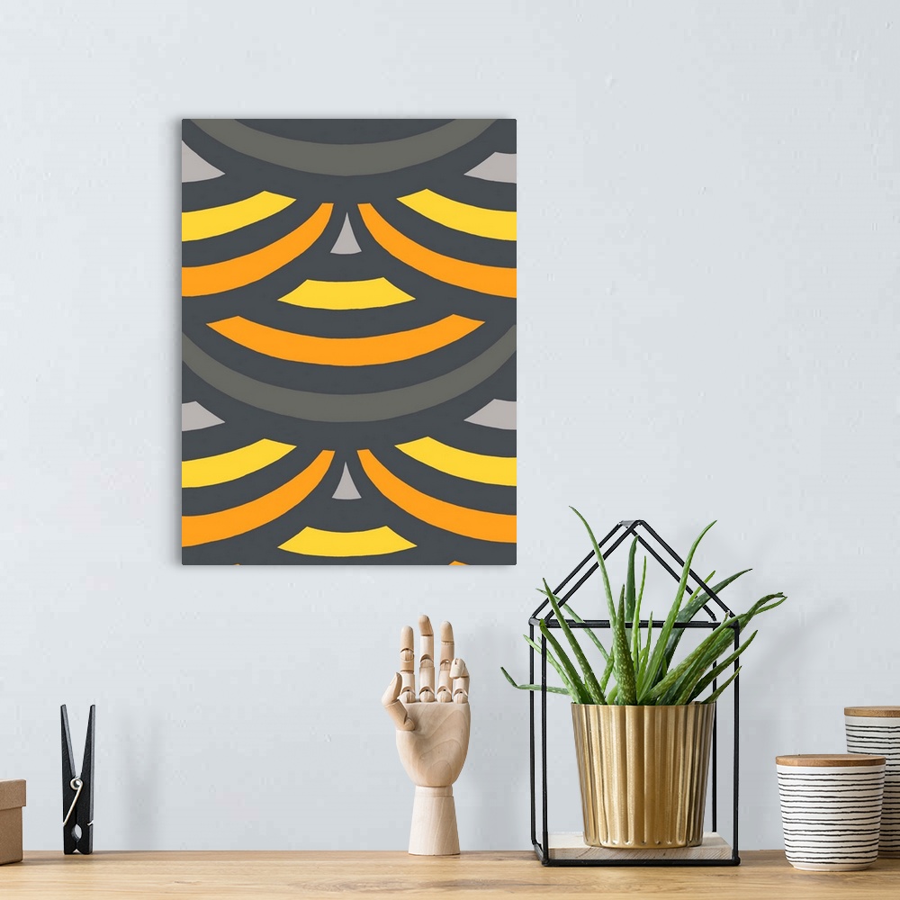 A bohemian room featuring Geometric abstract artwork in shades of yellow, orange, and grey.