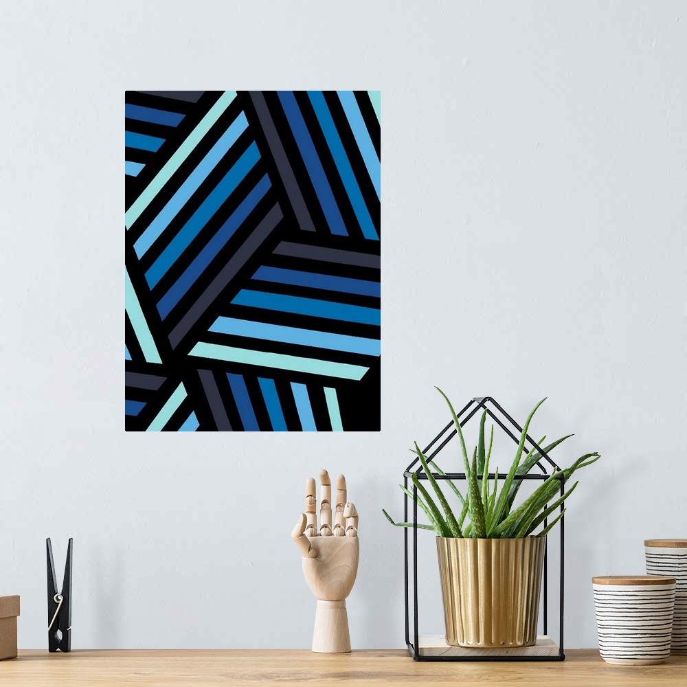 A bohemian room featuring Geometric abstract artwork in shades of black and blue.
