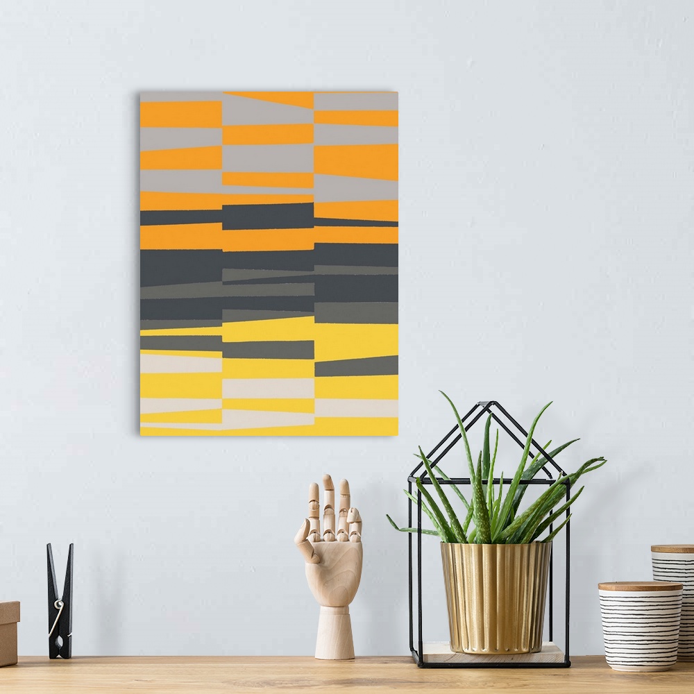 A bohemian room featuring Geometric abstract artwork in shades of yellow, orange, and grey.