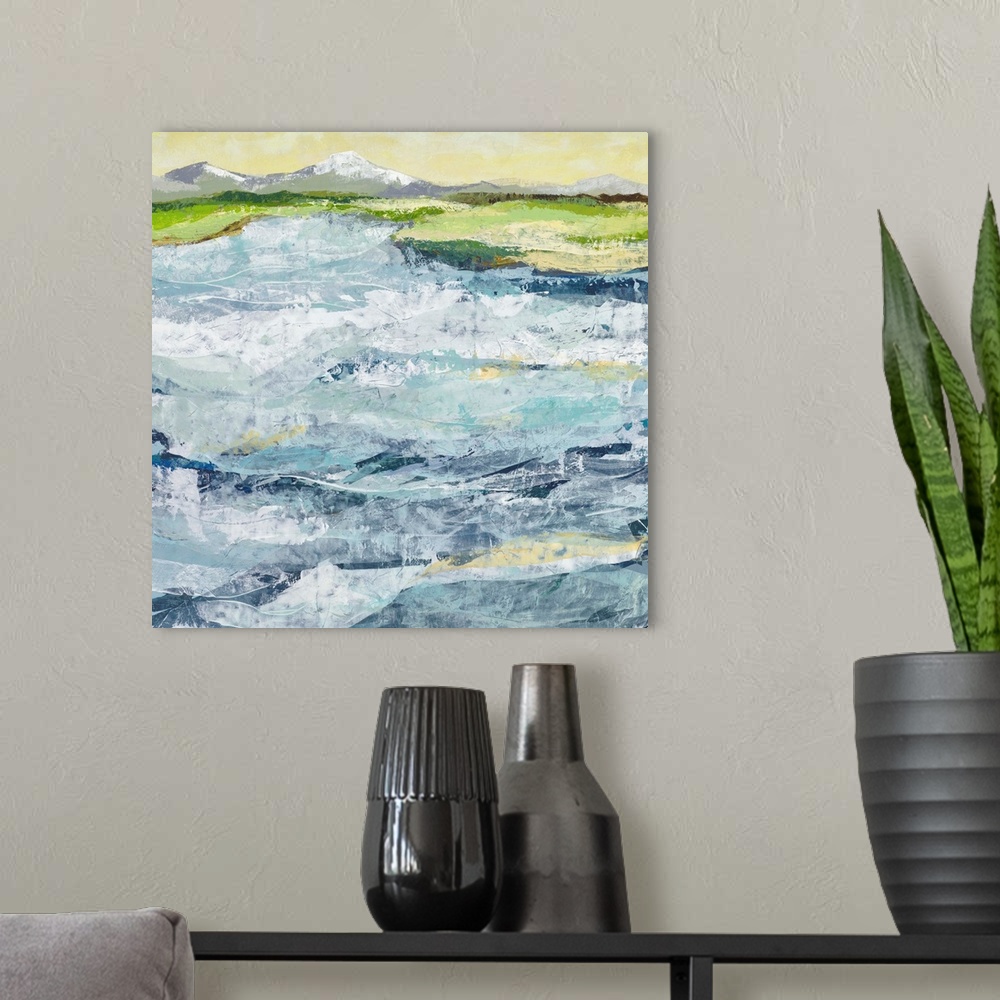 A modern room featuring Contemporary landscape painting of a blue toned field under a pale green sky.