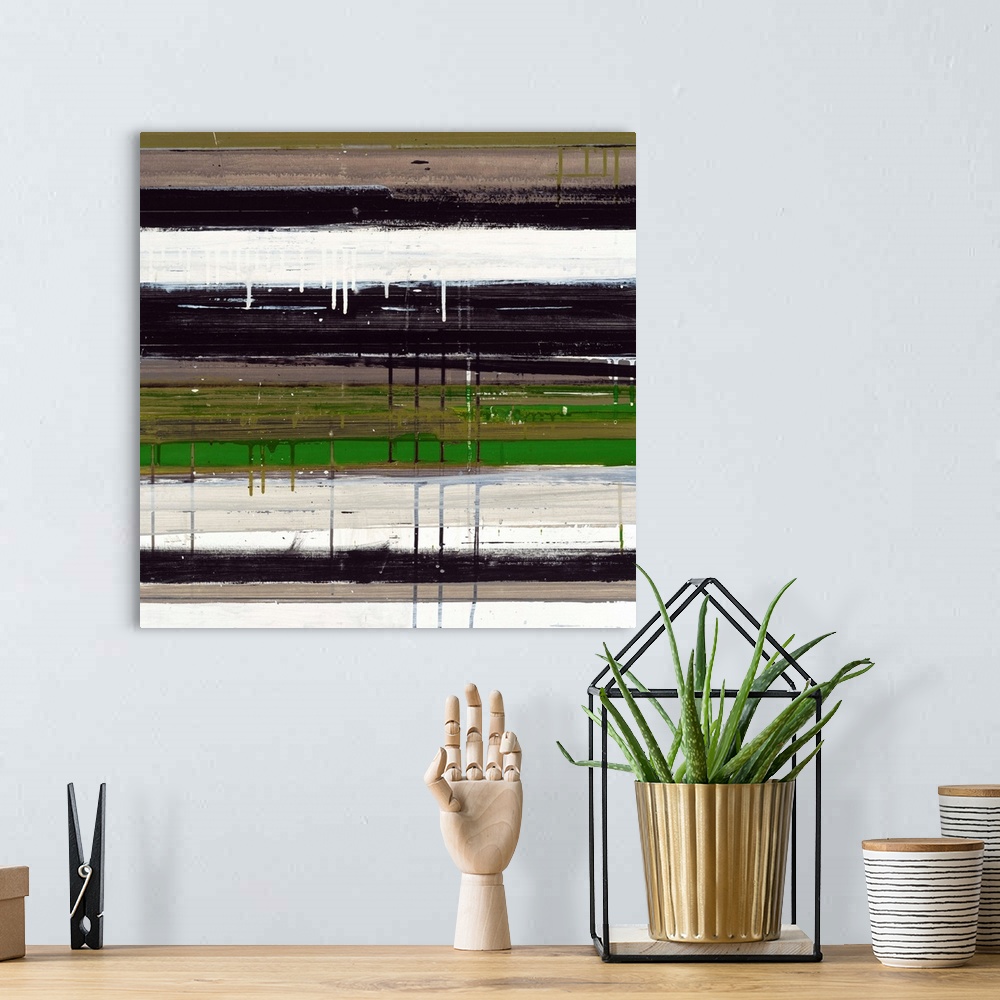 A bohemian room featuring Abstract artwork of dripping layers of paint in white, black, and green.