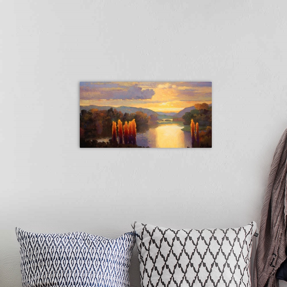 A bohemian room featuring Contemporary painting of a river lined with dense forests at dawn, with golden clouds in the sky.
