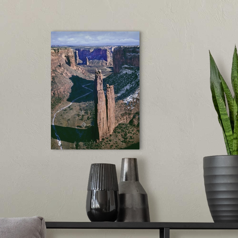 A modern room featuring A photograph of a towering rock formation in a desert canyon.