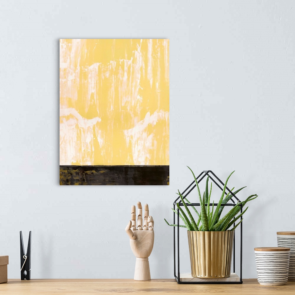 A bohemian room featuring Large abstract painting with a pastel yellow and white hue at the top and a black rectangular sec...