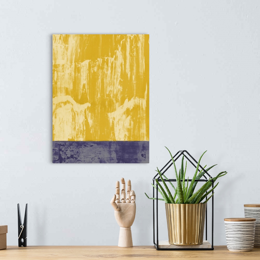 A bohemian room featuring Large abstract painting in shades of yellow and purple split into two sections.