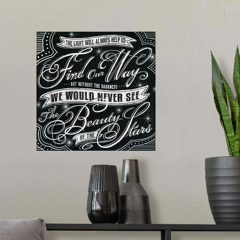 A modern room featuring Typography artwork in a chalkboard style reading "The light will always help us find our way but ...