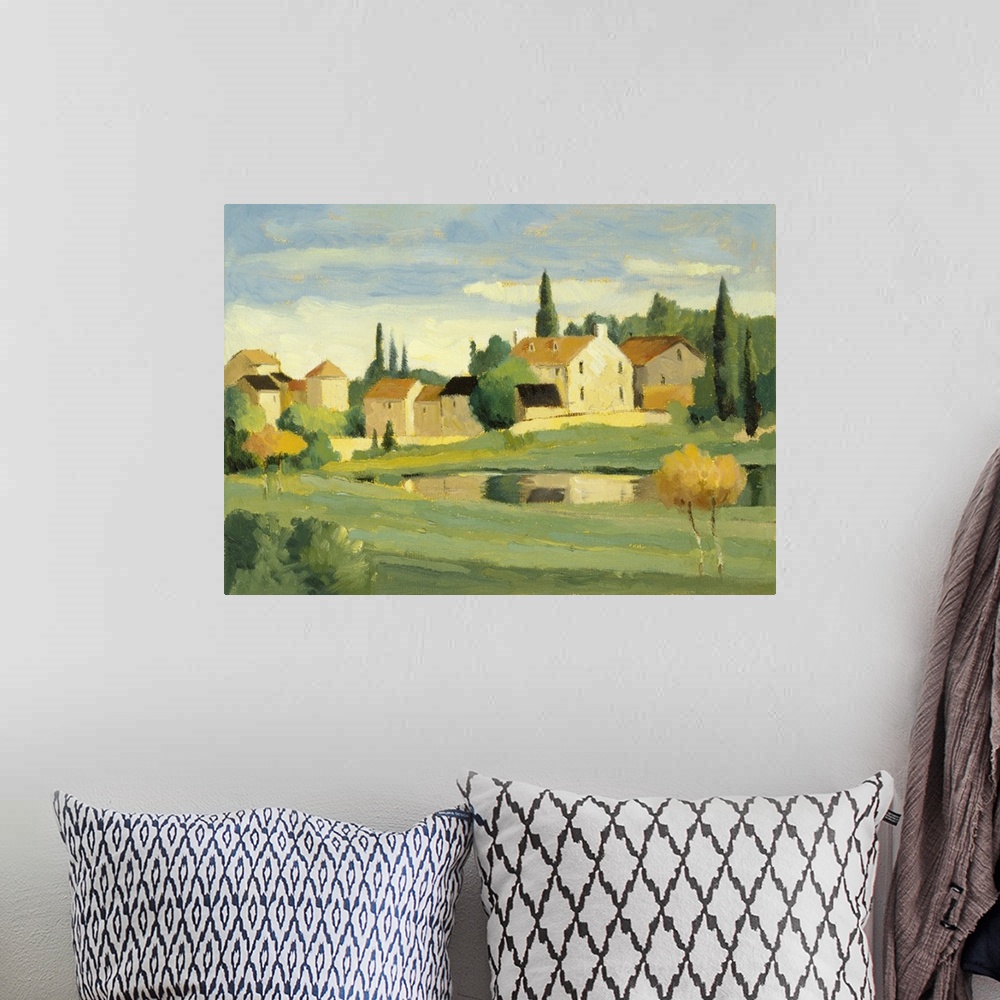 A bohemian room featuring Landscape painting with quaint country houses.