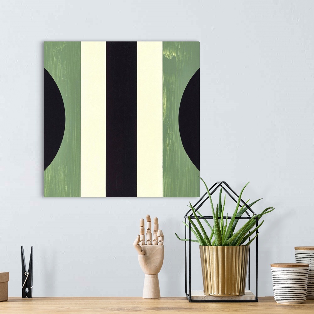 A bohemian room featuring Square symmetric abstract painting using geometric shapes in shades of green, black, and cream.