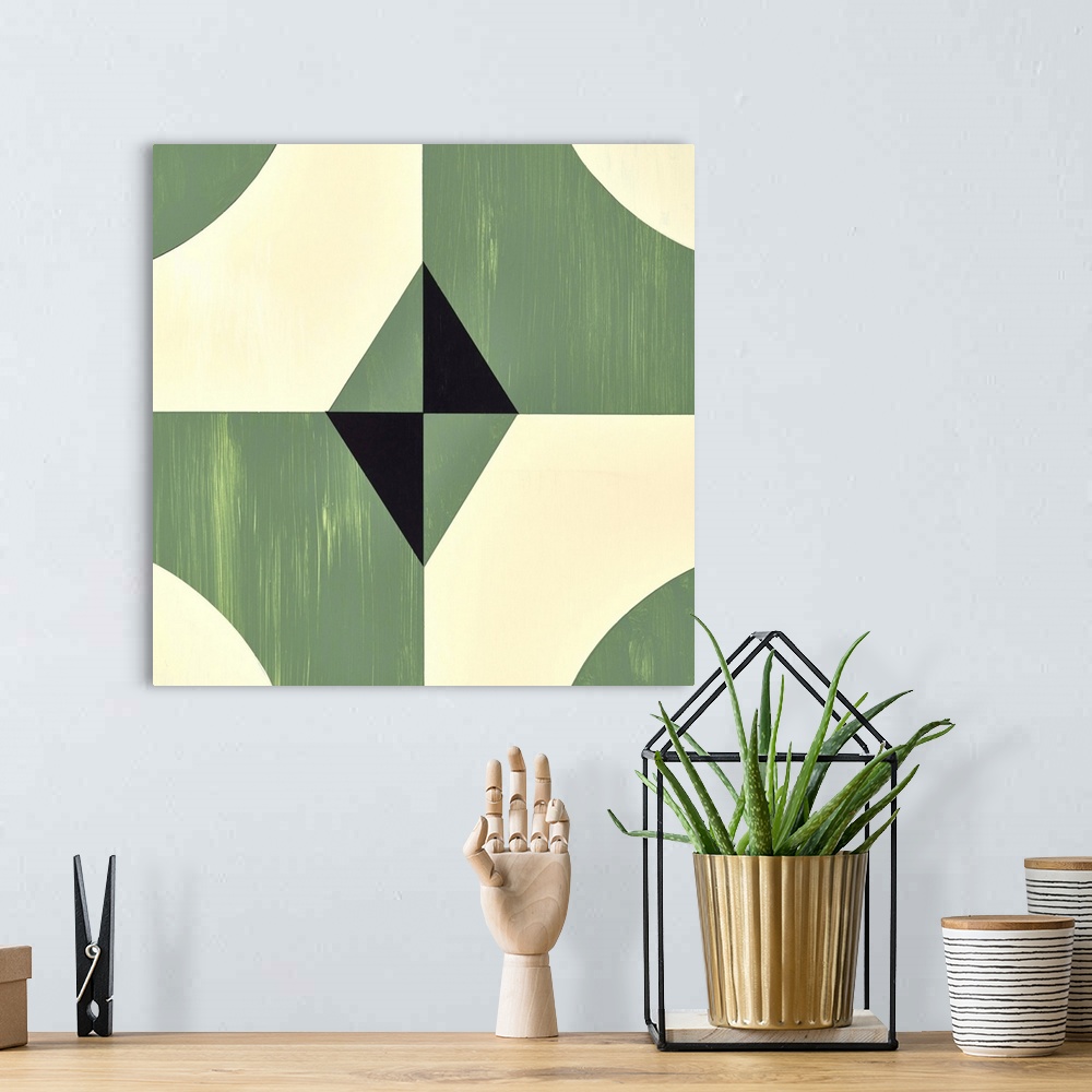 A bohemian room featuring Square symmetric abstract painting using geometric shapes in shades of green, black, and cream.