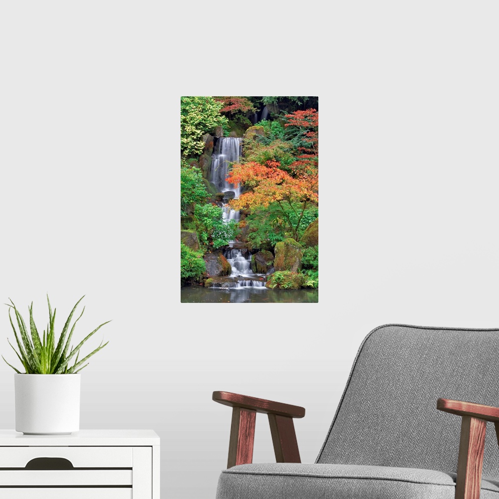 A modern room featuring Photograph of waterfall surrounded by autumn trees.